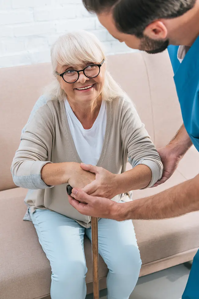 A caregiver providing relief to family members looking after an elderly loved one.